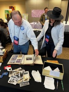 People looking at photo album at the 2024 Convention